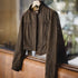 Brown jacket on a mannequin in front of a window